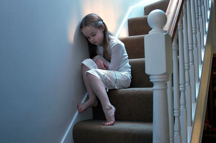 Sad child on stairs
